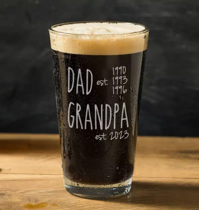 Father’s Day Gifts For New Grandpa - Beer glass full of dark beer that says Dad est 1990. 1993, and 1996 and Grandpa est 2023. 