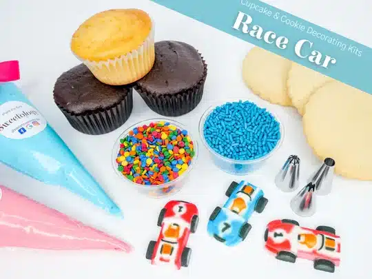 cookie or cupcake decorating kit with cupcakes, sprinkles, edible cars, icing tips and more shown. 