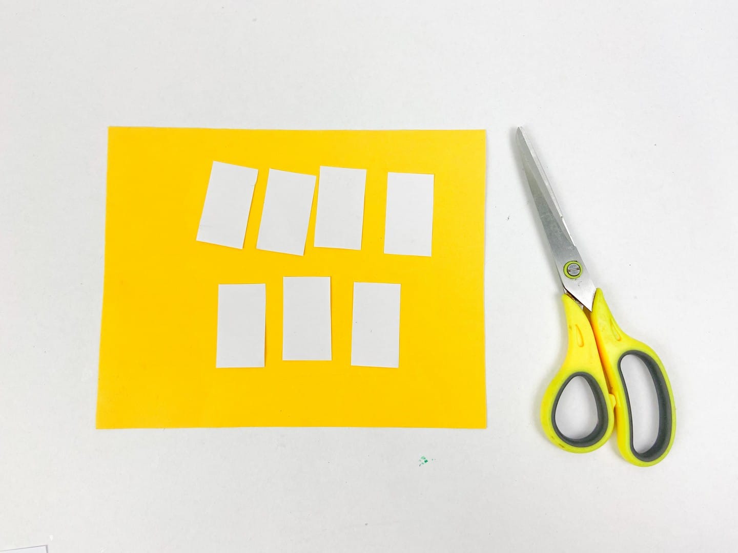 Yellow paper with white rectangles cut out.