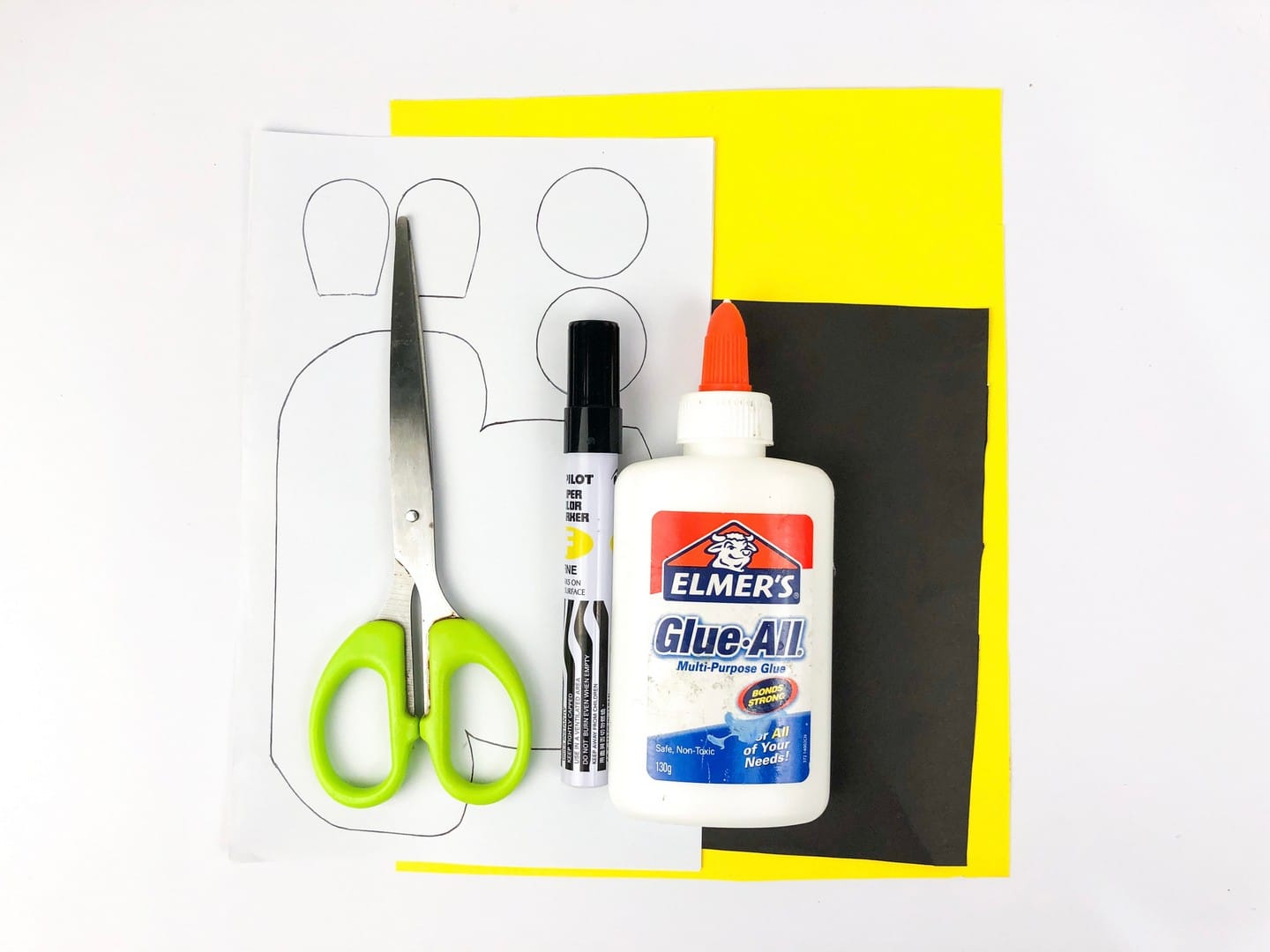 Materials needed to make card: scissors, marker, liquid glue, black, white, and yellow paper. 