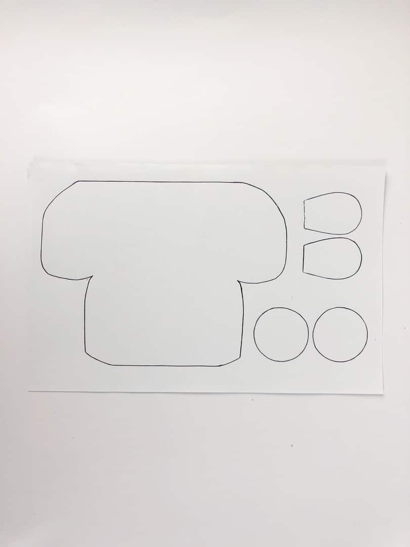 White paper with bus outline drawn on, with two round circles, and eye shapes. 