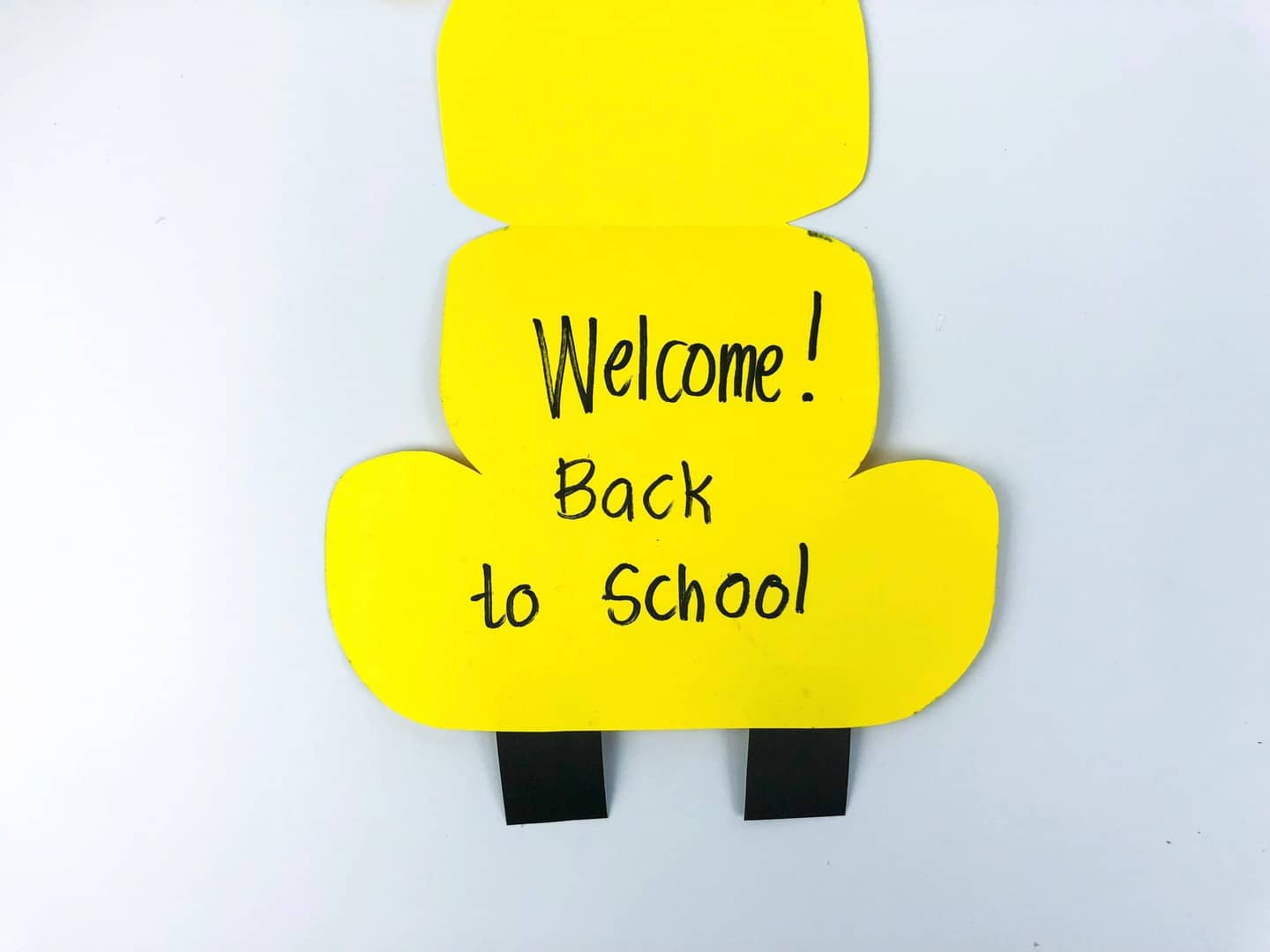 School bus open with Welcome!Back to school drawn on with black marker. 