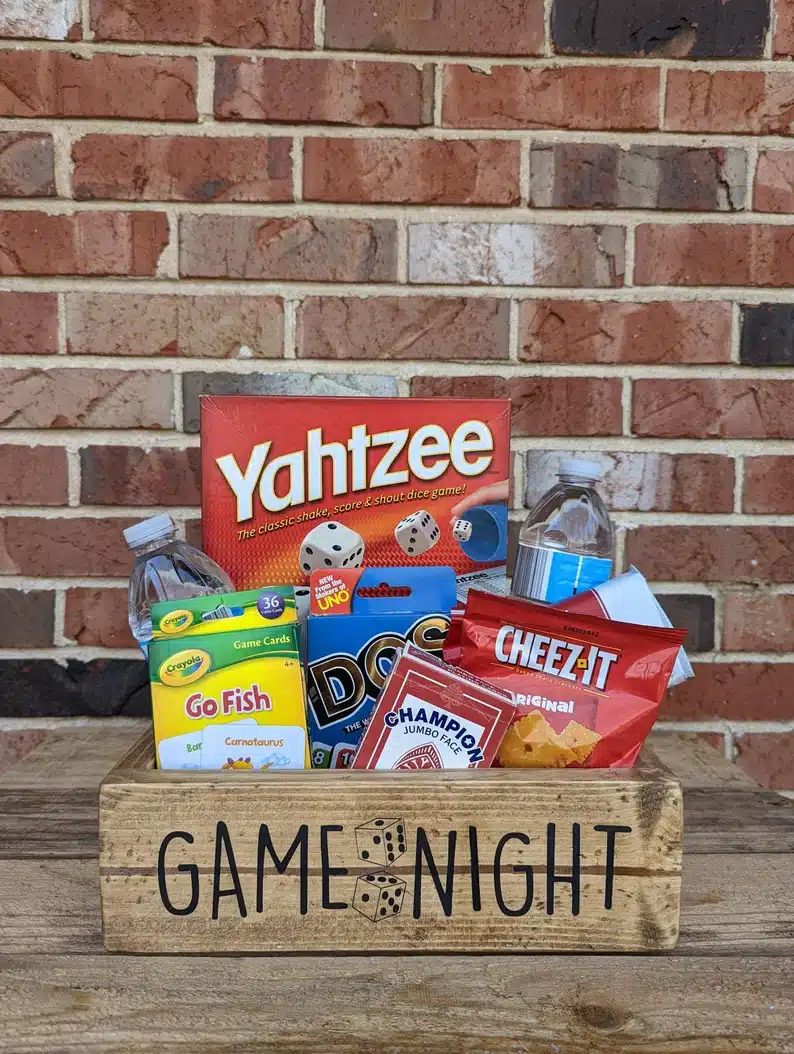 Welcome Gifts for Vacation Rental Guests - Games night wooden basket with games and snacks in it. 