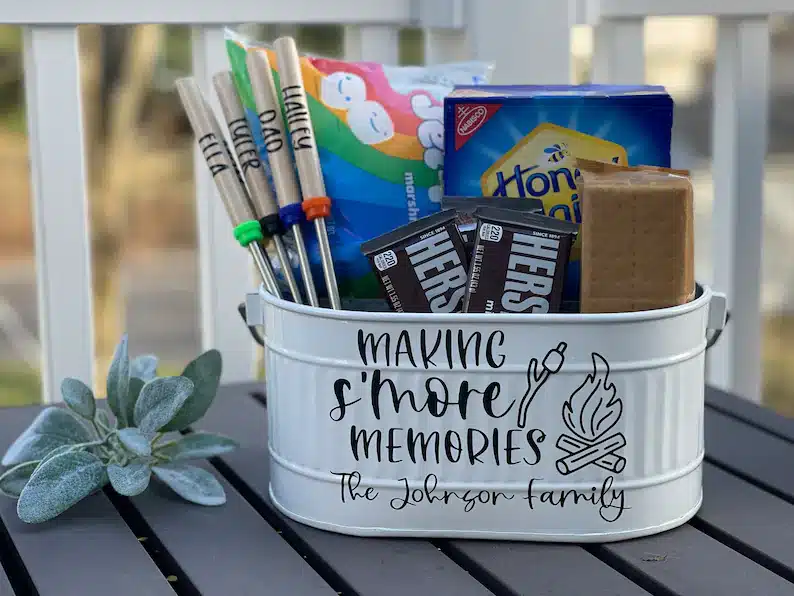 Welcome Gifts for Vacation Rental Guests - White tin bucket that says Making S'mores memories. filled with stuff needed for smores. 