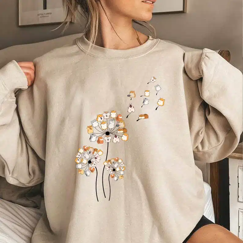 Unique Gift Ideas For Hamster Lovers - tan sweatshirt with hamsters as dandelions blowing in the wind. 