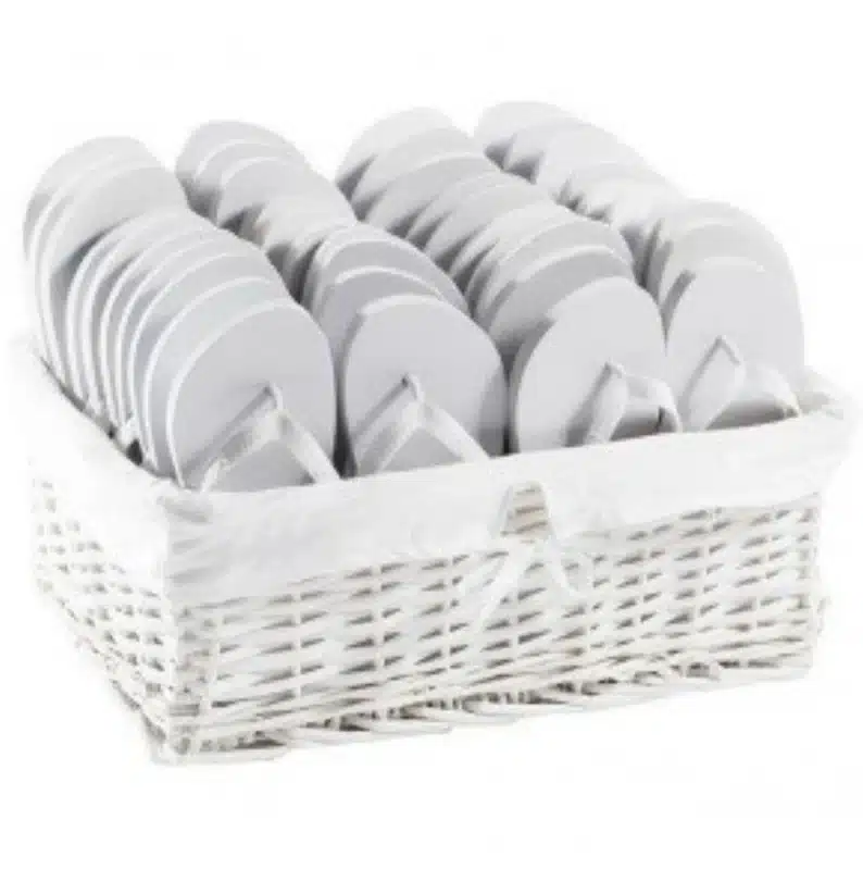 Welcome Gifts for Vacation Rental Guests - white basket full of white flip flips. 