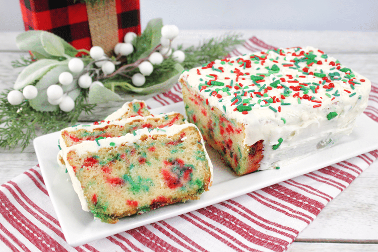 Multi-Color Christmas Bread Loaf - cake with multi colored sprinkles in the cake and on white glaze on top.
