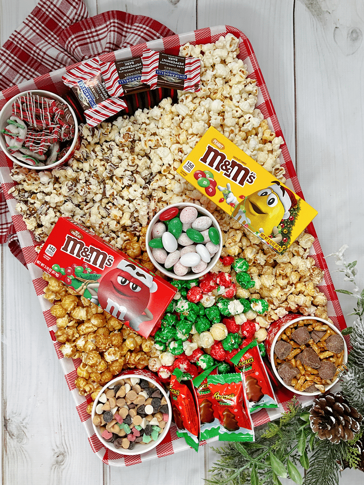 Holiday Movie Board Idea - popcorn, candies, and chocolates on a festive board.