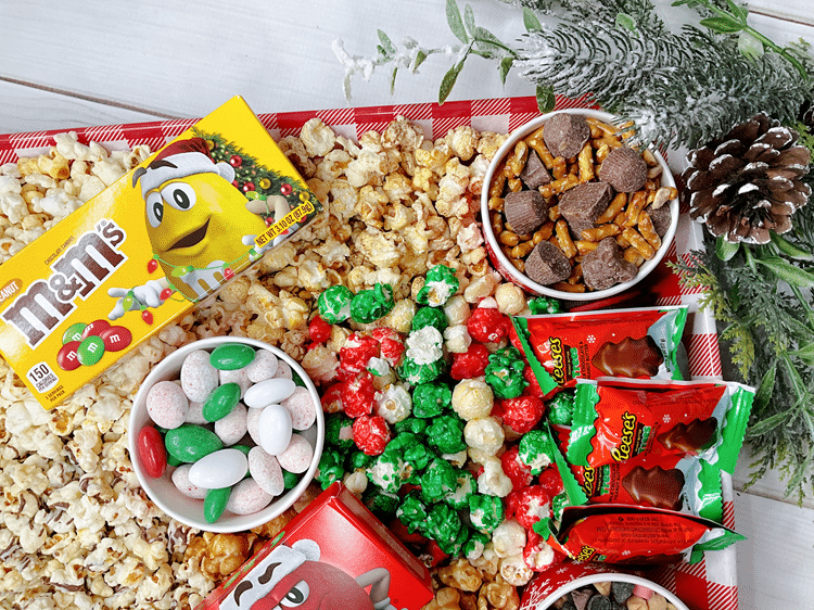 Holiday Movie Board Idea - holiday M&M, Reese chocolate trees, red and green popcorn, other popcorns, and more festive goodies.