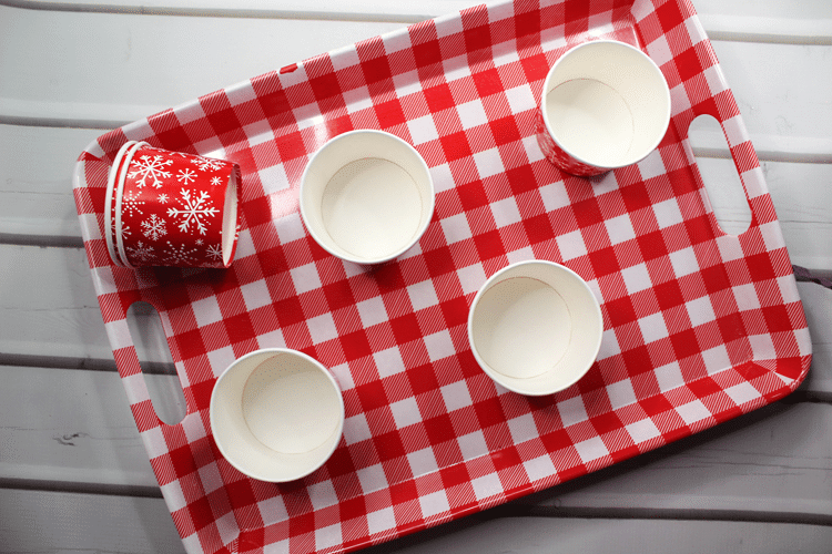 Above view of festive board with empty holiday cups arranged on it.