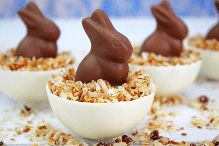 Easter Strawberry Shortcake Parfaits - close up of white chocolate bowl, topped with coconut and a chocolate bunny.
