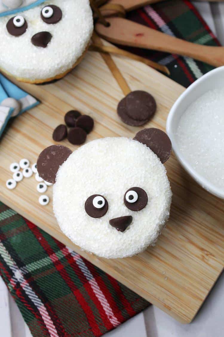 Adorable Sleepy Panda Cupcakes - abovew view with white icing, chocolate chips as eyes and nose with candy eyeballs added and two chocolate melts as ears.