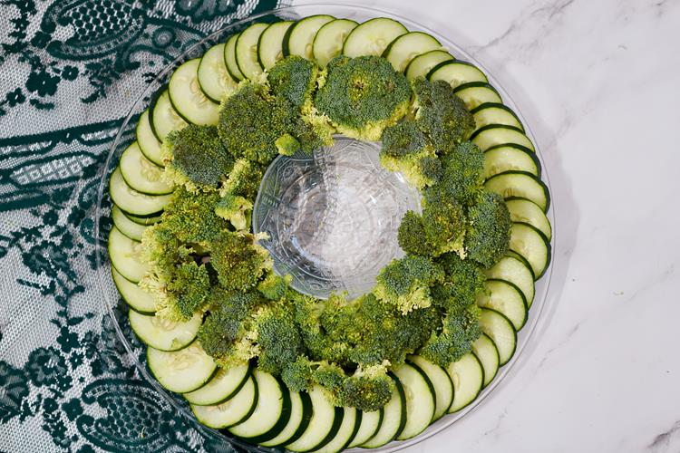 Vegetable Christmas Wreath Platter - large clear round plate with cucumbers on the outside and broccoli forming the inner ring.