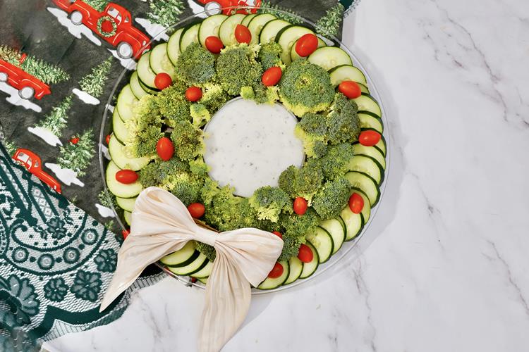 Above view of vegetable wreath with a large white bow on it
