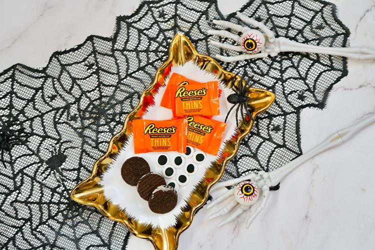 Halloween Reese's Peanut Butter Cup Bats - ingredients needed - Oreo cookies, candy eyes, and Reese's cups.