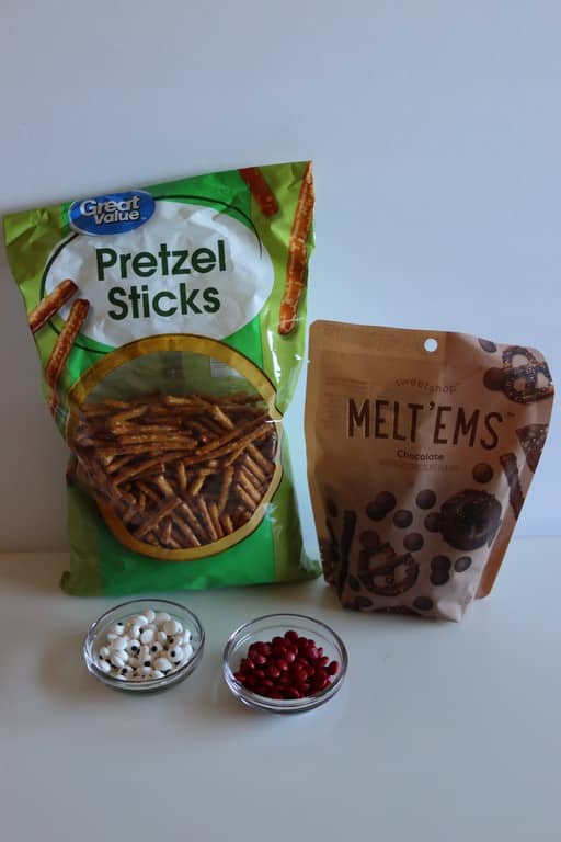 Ingredients required: mini pretzel sticks, melt em milk chocolate, bowl of candy eyes, and red mini M&m.
