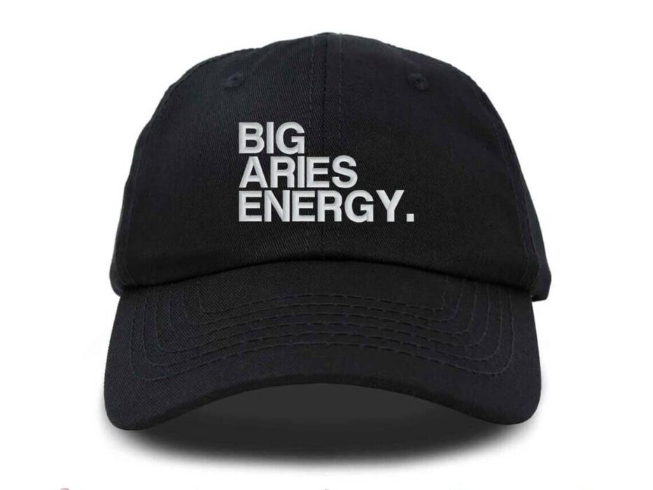 Black baseball cap with white stitched on font that says "Big Aries Energy"