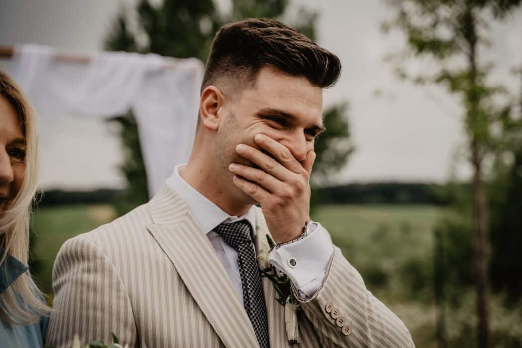 Groom covering his mouth
